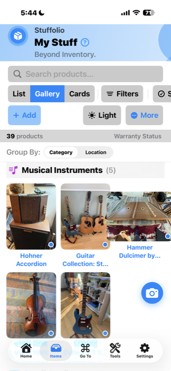 Stuffolio My Stuff gallery view showing musical instruments grouped by category with search, filters, and view options